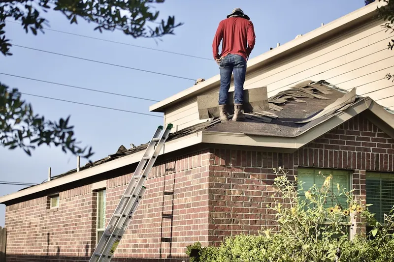 Professional roofer working on a residential roof in Villages of Bear Creek